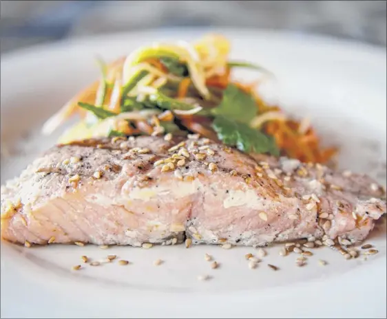  ?? Photos by Jim Franco / Special to the Times Union ?? Grilled salmon with sesame noodles: noodles, green onion, zucchini, carrot, cilantro and sesame seeds.