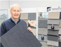  ?? ?? Wools of New Zealand CEO John McWhirter with a wool tile.