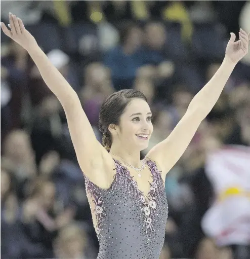  ?? DARREN CALABRESE / THE CANADIAN PRESS ?? Kaetlyn Osmond of Marystown, N.L., acknowledg­es the crowd following her short program Friday at the Canadian Figure Skating Championsh­ips in Halifax. Osmond was tops in the short program.