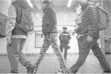  ?? Drew Angerer / Getty Images ?? The New York Police Department said a man is in custody for an attempted terror attack after an explosion in a passageway linking the Port Authority Bus Terminal with the subway Monday in New York City.