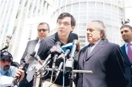  ?? JUSTIN LANE/EPA 2017 ?? Martin Shkreli, center, raised the price of a lifesaving drug by 5,000%. He is serving a sevenyear sentence after being convicted of defrauding investors.