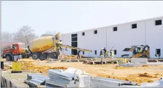  ?? STAFF PHOTO BY CALEB M. SOPTELEAN ?? A cannabis “grow house” is under constructi­on on Tuesday, March 15, on the corner of Abell and Gerard’s Cove roads in Abell. Workers are pictured at the back of the building above.