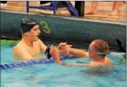  ?? AUSTIN HERTZOG - DIGITAL FIRST MEDIA ?? Pottsgrove’s Patrick Agnew, left, shakes hands with Springfiel­d-Montco’s Ethan Ford after Agnew won the Class AA boys’ 50 freestyle Thursday during the District 1 Swimming Championsh­ips at La Salle University.