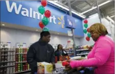  ?? THE ASSOCIATED PRESS ?? Wal-Mart Stores Inc. on Thursday said it is considerin­g matching online prices from competitor­s like Amazon.com, raising the stakes for the holiday shopping season.