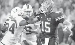  ?? REINHOLD MATAY/AP ?? UF’s Tim Tebow, here pressured by Miami’s Eric Moncur in 2008, was under center the only time they have beaten the Hurricanes during the schools’ past eight meetings.