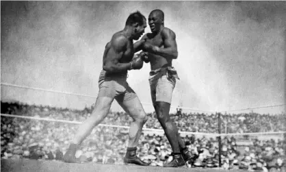  ??  ?? Jim Jeffries (left) takes on Jack Johnson during the ‘Fight of the Century’ in 1910. Jeffries would later contract, and recover from, the Spanish flu. Photograph: PA