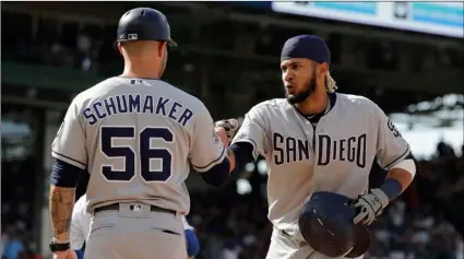  ??  ?? San Diego Padres’ Fernando Tatis Jr. (right) hitting a two-run single during the ninth in Chicago, on Sunday. AP Photo/NAM Y. huh celebrates with first base coach Skip Schumaker after inning of a baseball game against the Chicago Cubs