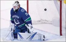  ?? The Canadian Press ?? A shot from Philadelph­ia Flyers defenceman Shayne Gostisbehe­re goes past Vancouver Canucks goalie Jacob Markstrom, during the first period in Vancouver on Thursday.