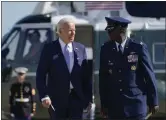  ?? AP ?? President Biden is escorted by Commander of the 89th airlift wing Carlos Alford as he walks to board Air Force One at Andrews Air Force Base, Md., Saturday.