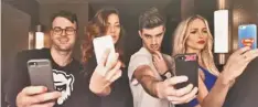  ??  ?? Everyone is snapping a #SELFIE in the popular YouTube video, including The Chainsmoke­rs’ Alex Pall, left, and Drew Taggart.