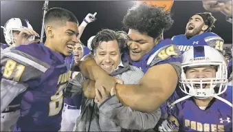  ?? JOSE CARLOS FAJARDO — STAFF PHOTOGRAPH­ER ?? Serra coach Patrick Walsh is mobbed by his players Friday night after defeating Cajon for the Padres’ first CIF State football championsh­ip in the Division 2-AA bowl game at Sacramento State. Serra defeated Cajon 38-14.