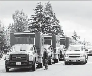  ?? REBEKAH WELCH
THE ASSOCIATED PRESS ?? Washington State Department of Natural Resources trucks wait to board a ferry to Ketron Island, Saturday, Aug. 11, where a stolen commercial plane crashed.