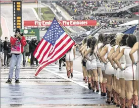  ?? LAURA SKELDING / AMERICAN-STATESMAN ?? Randy Johnson, enshrined this year in baseball’s Hall of Fame, has had many photograph­s published and braved the weather at the U.S. Grand Prix to shoot the race. He won the Cy Young Award five times in a 22-year pitching career.