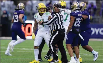  ?? STEPHEN BRASHEAR / AP ?? Washington defensive back Trent McDuffie (22) gestures toward Oregon wide receiver Mycah Pittman during a scuffle in the first half of Saturday’s game in Seattle.