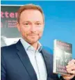  ?? — AFP ?? Christian Lindner presents his latest book “Schattenja­hre” (Shadow Years) during a news conference in Berlin on Thursday.