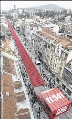  ??  ?? 11,541 chairs arranged in 825 rows form the appearance of a red river. The Serb siege of Sarajevo left 380,000 people without food, electricit­y, water or heating for 46 months.