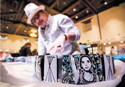  ?? PHOTOS BY GABRIELA CAMPOS/THE NEW MEXICAN ?? Kevin Pourier, Best of Show winner at this year’s Indian Market, speaks about his winning belt, titled Winyan Wánakiksin, which means ‘Women Defenders of Others,’ following the awards ceremony Friday at the Santa Fe Community Convention Center.