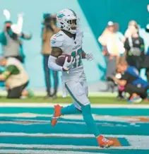  ?? JOHN MCCALL/SOUTH FLORIDA SUN SENTINEL ?? Dolphins wide receiver Jaylen Waddle runs into the end zone for a touchdown against the Jets during the first half Sunday at Hard Rock Stadium in Miami Gardens.