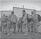  ?? SARAH SILBIGER, GETTY IMAGES ?? National Guard members arrive to protect the U. S. Capitol this week.