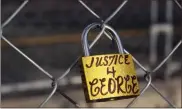  ?? Scott Olson/getty Images North America/tns ?? A lock is attached to the security fencing that surrounds the Hennepin County Government Center as the trial continues for former Minneapoli­s police officer Derek Chauvin on March 30.