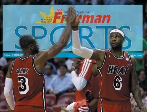  ?? ASSOCIATED PRESS ?? Dwyane Wade and LeBron James give each other a high five as the Miami Heat earned their franchise-record 15th straight victory with a 97-81 win over the Minnesota Timberwolv­es on Monday night (Tuesday morning Manila time).