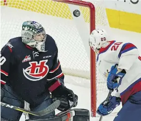  ?? LARRY WONG ?? Lethbridge Hurricanes goalie Liam Hughes makes a save on the Oil Kings’ David Kope on Sunday. Hughes helped his team win 5-2.