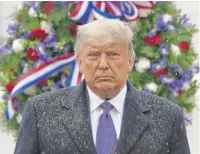  ?? PATRICK SEMANSKY/ AP ?? President Donald Trump on Wednesday at the Tomb of the Unknown Soldier at Arlington National Cemetery, which he visited with first lady Melania Trump.