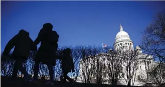  ?? AP FILE ?? ARCHAIC LAW: Pedestrian­s walk past the Rhode Island State House, in Providence, R.I., where it’s still legal for a man to rape his wife, according to state law, if she’s drunk or disabled.