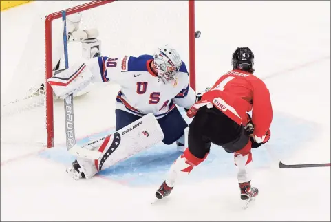  ?? Codie McLachlan / Getty Images ?? Canada’s Bowen Byram (4) takes a shot against U.S. goaltender Spencer Knight during the IIHF World Junior Championsh­ip gold medal game at Rogers Place last week in Edmonton.