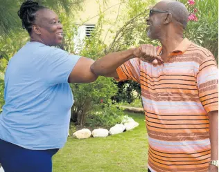  ??  ?? MP Colin Fagan, seen here greeting an unidentifi­ed resident, says he has been committed to infrastruc­ture developmen­t and other initiative­s in St Catherine South East.