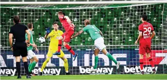  ?? — AFP photo ?? Leverkusen’s defender Mitchell Weiser (centre) scores during the German Bundesliga match against Werder Bremen in Bremen, northern Germany.