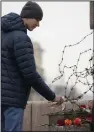  ?? (AP/Dmitri Lovetsky) ?? A man lays flowers paying respect to Alexei Navalny at the Memorial to Victims of Political Repression in St. Petersburg, Russia, on Saturday.