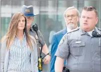  ??  ?? Fotis Dulos’ girlfriend, Michelle Troconis, leaves Stamford Superior Court on Tuesday morning with her attorney, at right. Her case was continued to July 18 in the brief appearance.