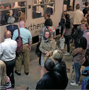  ?? PAUL BIGLAND. ?? Passengers wait to board a Northern service at Manchester Victoria on June 11. Northern has been bady affected by timetable chaos.