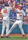  ?? THE ASSOCIATED PRESS ?? Oregon State’s Jack Anderson (29) and Michael Gretler celebrate after they scored against Mississipp­i State on a triple by Zak Taylor during the seventh inning of their College World Series game Friday in Omaha, Neb. Oregon State won 12-2.