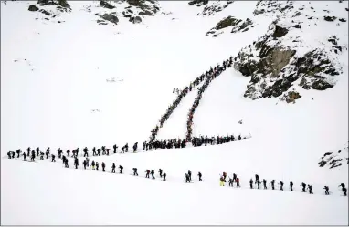  ?? ?? Competitor­s climb the Tsena Refien pass during the 24th Glacier Patrol race in the Alps, Switzerlan­d