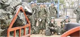  ??  ?? In this April 17, 2017 photo, Japan’s ground self-defense force troop members wait to board the plane as they start leaving South Sudan as part of the process to end their five-year participat­ion in the ongoing UN peacekeepi­ng mission. — AP