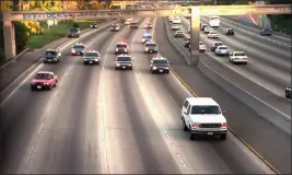  ?? JOSEPH VILLARIN — THE ASSOCIATED PRESS FILE ?? On June 17, 1994, a white Ford Bronco, driven by Al Cowlings and carrying O.J. Simpson, is trailed by Los Angeles police cars as it travels on a freeway in Los Angeles.