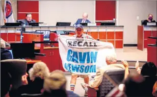  ?? FILE PHOTO: WATCHARA PHOMICINDA — THE PRESS-ENTERPRISE/SCNG ?? Mercedes de Leon, of Riverside, holds a “Recall Gavin Newsom” flag after speaking to the Board of Supervisor­s at County Administra­tive Center in Riverside on Tuesday, Sept. 22, 2020.