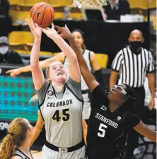  ?? David Zalubowski / Associated Press ?? Stanford’s Francesca Belibi blocks a shot by Colorado’s Charlotte Whittaker. Belibi had four points and four boards.