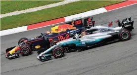  ??  ?? Max Verstappen’s Red Bull Racing RB13 passes Lewis Hamilton’s Mercedes-Benz F1 W08 Hybrid for the lead at the Malaysian Grand Prix.