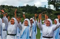  ??  ?? Fellow nuns of Maria Valentina de los Angeles perform during the recording of a music video at a convent.