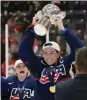  ?? NATHAN DENETTE/THE CANADIAN PRESS VIA THE ASSOCIATED PRESS ?? U.S. forward Hilary Knight (21) holds the cup as she celebrates with teammates after beating Canada in the gold medal game at the women’s world hockey championsh­ips in Ontario, Sunday, April 16, 2023.