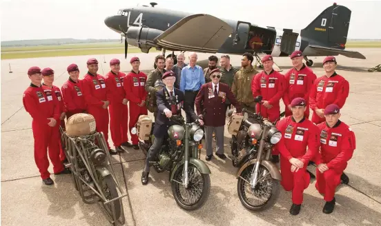  ??  ?? WW II veterans Jeffries and Glover pose with RAF's sky diving team the Red Devils at the Pegasus launch