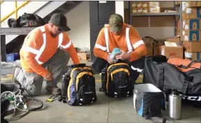  ?? ANDREA PEACOCK/The Okanagan Weekend ?? Kevin Hopper, left, and Travis Briard, powerline technician­s with FortisBC in Kelowna, were busy packing equipment that they will need for an emergency response trip to the Turks and Caicos Islands, which has been affected by Hurricane Irma.