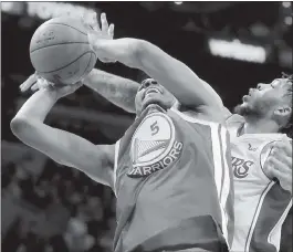  ?? PHOTOS BY CHRIS CARLSON — ASSOCIATED PRESS ?? Warriors forward Kevon Looney, left, and Los Angeles Lakers forward Brandon Ingram battle for a rebound during the first half of their contest at Staples Center on Monday.