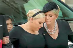  ?? — AFP ?? Meghan McCain and her mother Cindy McCain embrace as the casket of the late Senator John McCain arrives at the Washington National Cathedral for the funeral service on Saturday.