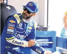  ?? TERRY RENNA/ASSOCIATED PRESS ?? Jimmie Johnson signs autographs at his garage during a practice session at Daytona Internatio­nal Speedway last week. He has seven NASCAR titles, tied with Dale Earnhardt and Richard Petty.