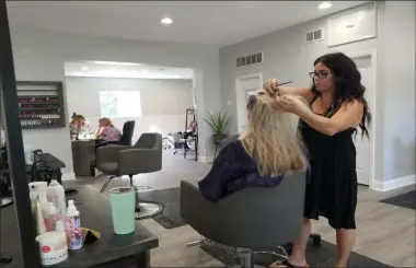  ?? JORDANA JOY - THE MORNING JOURNAL ?? Jill Hansing, 38, of Avon, left, gets her hair done as a longtime client of Brittney Haponek, right, owner of Salon Zero Eight Nine, 3619 Liberty Ave. in Vermilion. The salon opened this month.