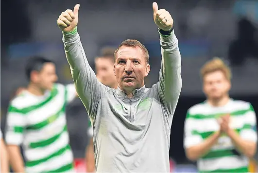  ?? Picture: SNS. ?? Celtic manager salutes the travelling fans after Celtic confirmed their place in the Champions League group stages.